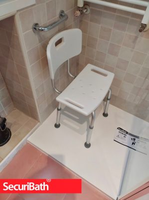 plato de ducha con una silla para baño